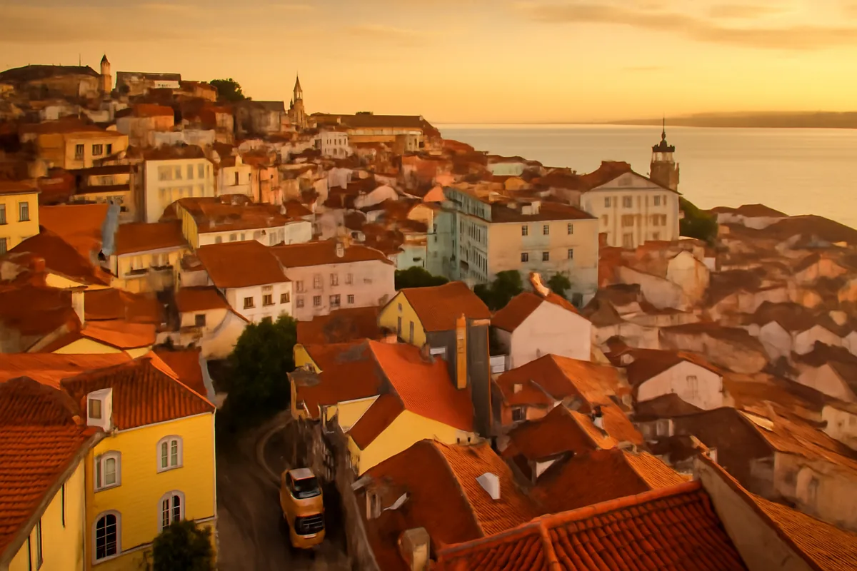 Panoramic golden hour view of Lisbon's iconic hillside neighborhoods with terracotta rooftops, yellow tram tracks, and the Tagus River visible in the distance