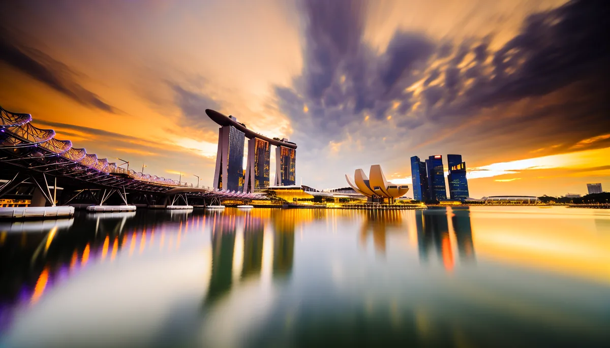 Singapore's iconic Marina Bay Sands hotel and skyline reflected in calm waters during golden hour sunset
