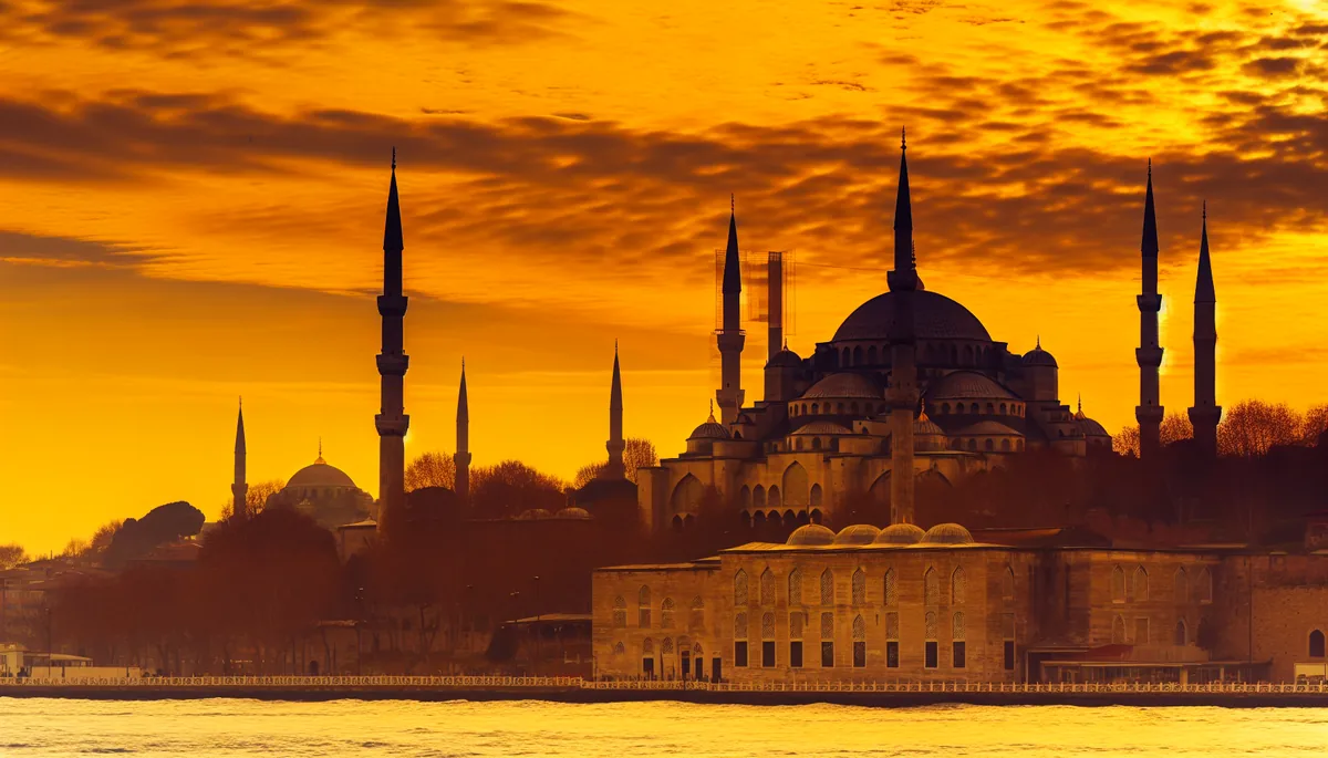 Stunning sunset view of Istanbul's historic skyline featuring the Blue Mosque and Hagia Sophia with the Bosphorus strait in the foreground
